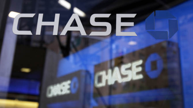 FILE - This file photo made April 13, 2010, shows the door of a branch Chase Bank in New York. JPMorgan Chase revealed during the first week of October 2014 that 76 million households were affected by a cyberattack against the bank this summer. (AP Photo/Richard Drew, File)