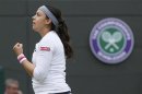 Marion Bartoli of France reacts after defeating Sloane Stephens of the U.S. in their women's quarter-final tennis match at the Wimbledon Tennis Championships, in London
