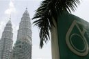 A Petronas logo is seen near its twin towers in Kuala Lumpur