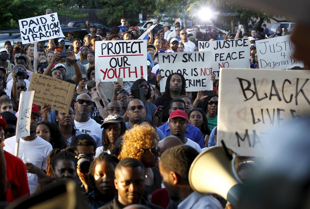 Protesters listen during a rally against what demonstrators call police brutality in McKinney, Texas