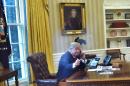 US President Donald Trump(L)seen through an Oval Office window, speaks on the phone to King Salman of Saudi Arabia in the Oval Office of the White House on January 29, 2017 in Washington, DC