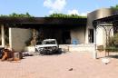 A burnt house and a car are seen inside the US Embassy compound on September 12, 2012 in Benghazi, Libya