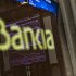 The Stock Exchange main display is reflected on a Bankia sign in Madrid, Monday, May 28, 2012.  Shares in Spanish bank Bankia, one of the banks hardest hit by Spain's real estate collapse over the past four years, fell 28 per cent on opening in Madrid on Monday, the bank's first day back on the stock exchange following its announcement Friday that it would need Euro 19 billion ($23.8 billion) bailout to bolster its defenses.(AP Photo/Daniel Ochoa de Olza)