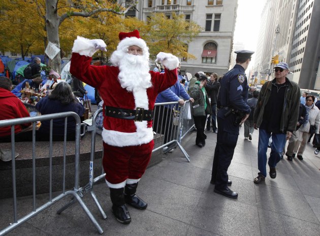 A man dressed as Santa Claus stands in front of the "Occupy Wall Street" encampment in Zuccotti Park in New York