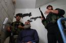 Sunni Muslim fighters stand with their weapons inside a building in Tripoli, northern Lebanon