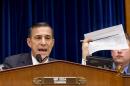 FILE - In this Nov. 13, 2013 file photo, House Oversight Committee Chairman Rep. Darrell Issa, R-Calif., holds up a checklist related to the preparation for the implementation of the Obamacare healthcare program, and specifically, the HealthCare.gov website, on Capitol Hill in Washington. For two months, the talk was all about computer code. About response times. About glitches and bugs. Issa, who misses no opportunity to investigate perceived shortcomings in the health care program, devoted a full hearing to the "limitations of Big Government" when it comes to health care. (AP Photo/J. Scott Applewhite, File)
