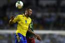 Gabon's forward Pierre-Emerick Aubameyang heads the ball with Cameroon's defender Ambroise Oyongo (back) during the 2017 Africa Cup of Nations group A football match between Cameroon and Gabon on January 22, 2017