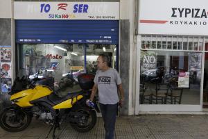 Mechanic Giorgos Prasinoudis steps out of his closed …