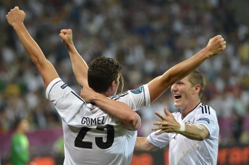 Germany's Mario Gomez and Bastian Schweinsteiger celebrate after their team scored during the Euro 2012 soccer championship Group B match between Germany and Portugal in Lviv, Ukraine, Saturday, June 9, 2012. (AP Photo/Martin Meissner)