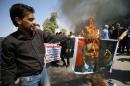 Protesters burn a picture of Turkey's President Erdogan in Basra