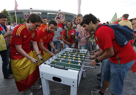 Spain's fans play table soccer before their Euro 2012 semi-final soccer match against Portugal in Donetsk