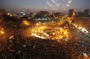 Protesters opposing Egyptian President Mursi shout solgans and make fireworkes during a protest in Tahrir square in Cairo