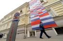 A security guard walks outside the Dutch embassy in Moscow, on October 16, 2013