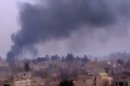 In this image taken from video obtained from the Ugarit News, which has been authenticated based on its contents and other AP reporting, Smoke rises from heavy shelling in Deir el-Zour, Syria, on Monday, Jan. 28, 2013. (AP Photo/Ugarit News via AP video)