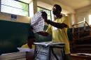 Election officials count ballots at a polling station in Port-au-Prince, Haiti, on October 25, 2015 after a poll that saw large turnout without major incidents