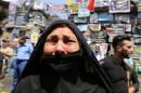 An Iraqi woman cries on July 7, 2016 in front of a memorial for the victims of a bombing which claimed the lives of over 200 people in Baghdad's Karrada neighbourhood