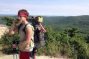 Hiker Matthew Donnelly of Milford, Pennsylvania, uses his cell phone on the Appalachian Trail in Bear Mountain