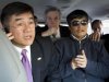 In this photo released by the US Embassy Beijing Press Office, U.S. ambassador to China, Gary Locke, left, makes a phone call as he accompanies blind lawyer Chen Guangcheng, right, in a car en route from the U.S. Embassy to a hospital in Beijing, Wednesday, May 2, 2012. At center is language attache James Brown. (AP Photo/U.S. Embassy Beijing Press Office, HO)