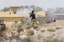 A member of the Iraqi pro-government forces fires a rocket-propelled grenade launcher during an operation in al-Shahabi village, east of Fallujah, in an operation to retake the city from Islamic State group, on May 24, 2016