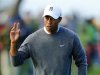 U.S. golfer Tiger Woods waves to fans after making par on the fifth hole during the fourth round play at the Farmers Insurance Open in San Diego