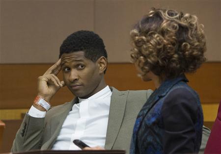 R&B singer Usher waits as he speaks with a member of his legal staff before a custody hearing at Fulton County Courthouse in Atlanta, Georgia August 9, 2013. Tameka Foster, ex-wife of Usher is seeking custody of their two young sons after one of them was hospitalized in Atlanta following a swimming pool accident this week. REUTERS/Christopher Aluka Berry