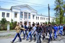 Schoolchildren march in front of a school where Tamerlan Tsarnaev, who was dubbed a suspect in the Boston Marathon bombings, studied, in a small Kyrgyz city Tokmok east of the country's capital of Bishkek, on Friday, April 20, 2013. Tamerlan Tsarnaev was an amateur boxer with muscular arms and enough brio to arrive at a sparring session without protective gear. The Tsarnaev family arrived in the United States, seeking refuge from strife in their homeland. The family had moved from Kyrgyzstan to Dagestan, a predominantly Muslim republic in Russia's North Caucasus that has become an epicenter of the Islamic insurgency that spilled over from Chechnya. (AP Photo/Abylay Saralayev)