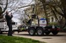 Man takes pictures of a gyro copter that was flown onto the grounds of the U.S. Capitol as it is towed from the west front lawn in Washington