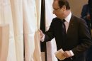 France's President Hollande enters voting both in the legislative elections at the polling station in Tulle
