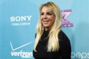 Spears poses at the party for the television series "The X Factor" finalists in Los Angeles