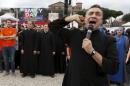 A priest shouts slogans during a rally against same-sex unions and gay adoption in Rome