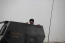 A soldier with Iraq's elite counterterrorism forces peers from the gun turret of a Humvee on the front line in Fallujah, Iraq, Sunday, June 5, 2016. Iraqi forces are pushing their way into the city to retake it from Islamic State militants. (AP Photo/Maya Alleruzzo)