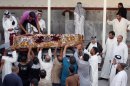 Mourners unload the coffin of Imad Younis, 22, who was killed in a car bomb attack, in the Shiite holy city of Najaf, 100 miles (160 kilometers) south of Baghdad, Iraq, Thursday, Aug. 15, 2013. A wave of car bombs on Wednesday killed and wounded dozens of people, the latest attacks in a months-long surge in violence. More than 3,000 people have been killed in violence during the past few months, raising fears Iraq could see a new round of widespread sectarian bloodshed similar to that which brought the country to the edge of civil war in 2006 and 2007. (AP Photo/Haider Hamdani)