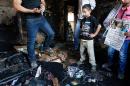 Palestinians look at the damage in a house set on fire by Jewish settlers, where 18-month-old Palestinian toddler Ali Saad Dawabsha died, in the West Bank village of Duma, July 31, 2015