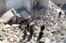 Residents look for survivors amidst the rubble after an airstrike on the rebel-held Old Aleppo