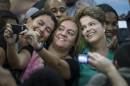 Brazil's President Dilma Rousseff, right, who is running for reelection with the Workers Party (PT), poses for selfie photos with supporters after a meeting with athletes as she campaigns in Rio de Janeiro, Brazil, Tuesday, Sept. 30, 2014. Brazil will hold general elections on Oct. 5. (AP Photo/Felipe Dana)