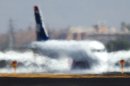 A jet looks like it is melting into the runway as it is distorted by the heat waves rising up from the north runway at Sky Harbor International Airport, Friday, June 28, 2013, the hottest day of the year so far. (AP Photo/The Arizona Republic, Tom Tingle) MARICOPA COUNTY OUT; MAGS OUT; NO SALES