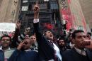 FILE - In this Tuesday, March 26, 2013 file photo, Former presidential candidate Khaled Ali, center, chants slogans during a protest in front of the general prosecutor's office in Cairo, Egypt. Ali says he will not take part in upcoming presidential elections, calling them a 