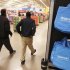 Workers walk through a new Wal-Mart store in Chicago