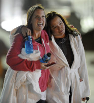 Kristina Courson, left, of Paris, Texas, is embraced by Jamie Hilliard, of Denison, Texas, after getting off the cruise ship Carnival Triumph in Mobile, Ala., Thursday, Feb. 14, 2013. The ship with more than 4,200 passengers and crew members has been idled for nearly a week in the Gulf of Mexico following an engine room fire. (AP Photo/G M Andrews)