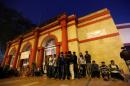 People queue as they wait for the post-office to open to exchange their old high denomination bank notes in the early hours, in New Delhi