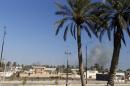 Smoke rises above a building during an air strike in the city of Ramadi
