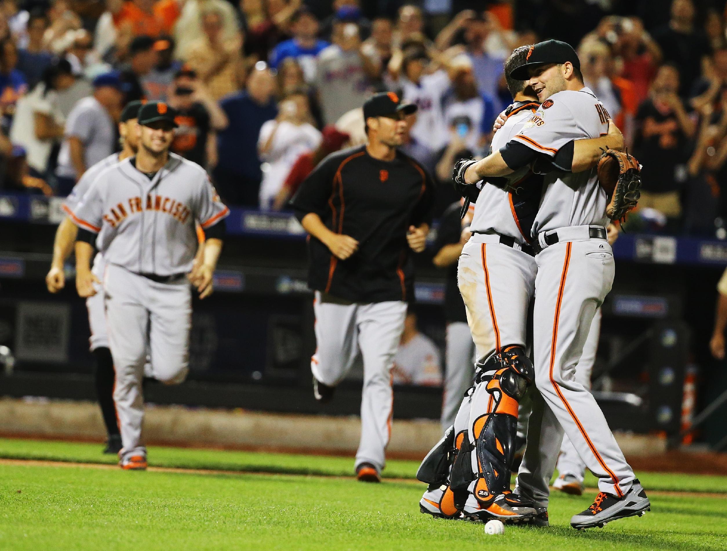 Chris Heston, right, celebrates his no-hitter with Buster Posey on Tuesday night. (Getty)