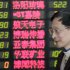 An investor looks at the stock price monitor at a private securities company on Thursday, March 28, 2013, in Shanghai, China. Renewed jitters about the debt crisis in Europe sent Asian stock markets lower Thursday. (AP Photo/Eugene Hoshiko)