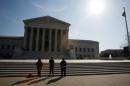 Three anti-abortion protestors are seen outside U.S. Supreme Court building is seen in Washington