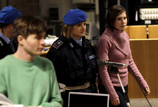 FILE - In this Saturday, Dec. 18, 2010 file photo U.S. student Amanda Knox, right, walks past Raffaele Sollecito, as she arrives after a break to attend a hearing in her appeals trial, at Perugia's courthouse, Italy. Italy's highest criminal court has overturned the acquittal of Amanda Knox and of her former Italian boyfriend, Raffaele Sollecito, in the slaying of her British roommate and ordered a new trial. The Court of Cassation ruled Tuesday, March 26, 2013 that an appeals court in Florence must re-hear the case against the American and her Italian-ex-boyfriend for the murder of 21-year-old Meredith Kercher (AP Photo/Alessandra Tarantino)