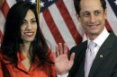 FILE - In this Jan. 5, 2011, file photo, Anthony Weiner and his wife Huma Abedin pose for photographs after the ceremonial swearing in of the 112th Congress on Capitol Hill in Washington. Abedin, who was notably absent five months later when Weiner resigned his congressional seat and admitted sending lewd Twitter photos to women, has been a key player in his surging mayoral run. She's appeared in his campaign launch video, raised tens of thousands of dollars and joined him on the campaign trail. (AP Photo/Charles Dharapak, File)