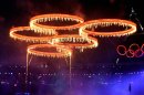 London: The Olympic rings are illuminated with pyrotechnics as they are raised above the stadium during the Opening Ceremony at the 2012 Summer Olympics in London on Friday. PTI Photo by Manvender Vashist(PTI7_28_2012_000024B)