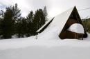 An above-average amount of snow covers a small cabin near the first snow survey of winter conducted by the California Department of Water Resources in Phillips, California