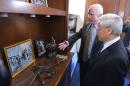 Vietnam's Communist Party General Secretary Nguyen Phu Trong (R) looks at a 1967 photo during a visit to the office of Senator John McCain on July 8, 2015 on Capitol Hill in Washington, DC