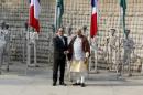 French President Hollande shakes hands with India's Prime Minister Modi during their visit to the Rock Garden in Chandigarh